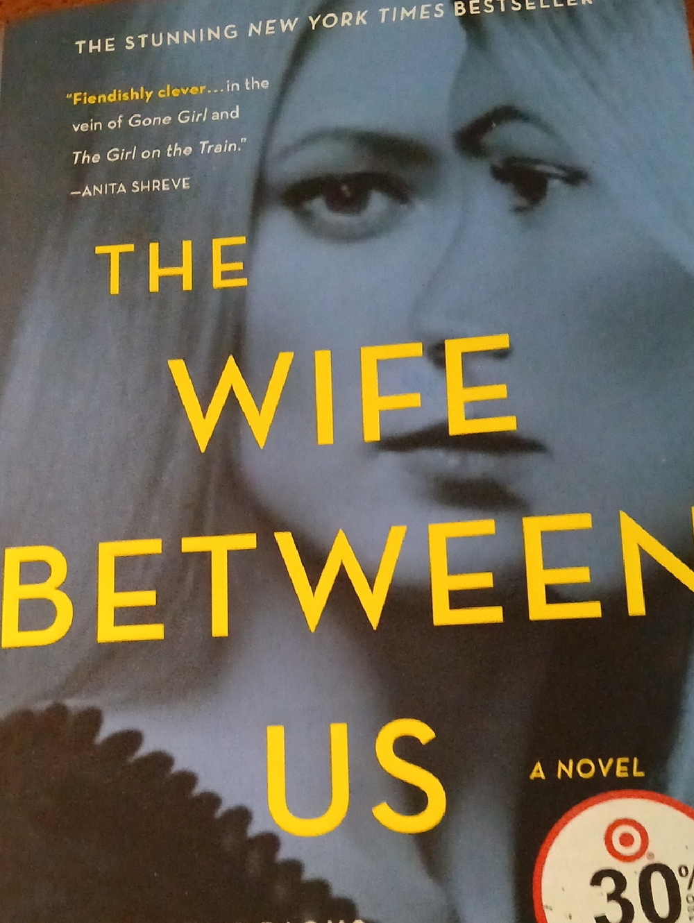 The Wife Between Us - Yellow Text on Blue Cover
